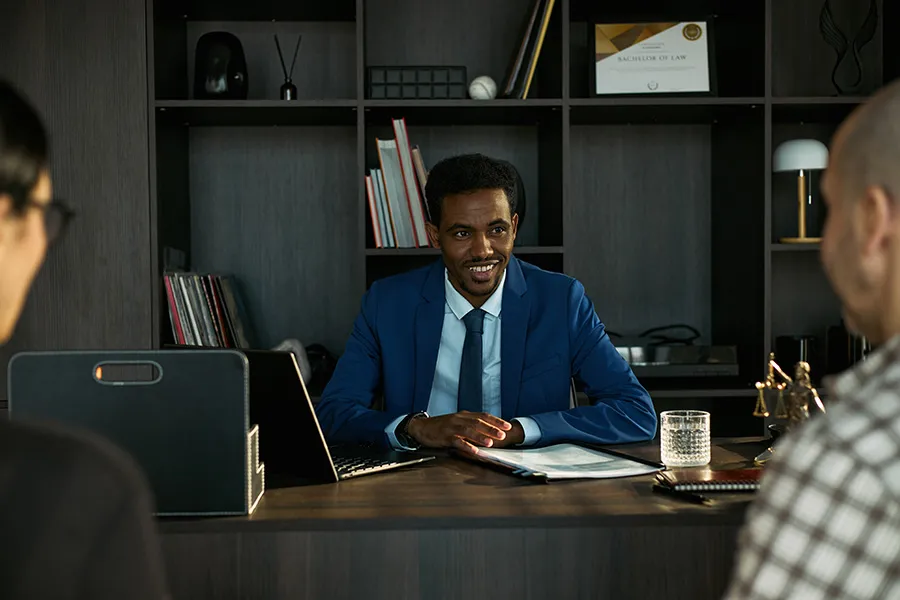 Attorney meeting with prospective clients in his office — representing law firm websites that make it easier to request consultations, begin the legal intake process, and connect with the appropriate attorney.