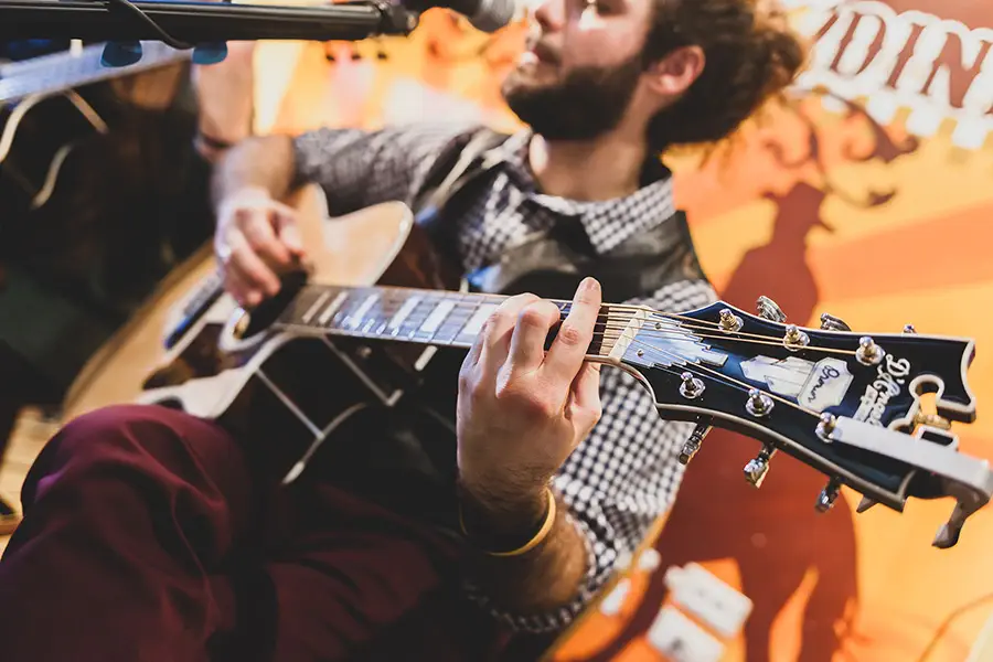 Guitarist performing live on stage — representing professional website design for Nashville musicians, bands, and songwriters.